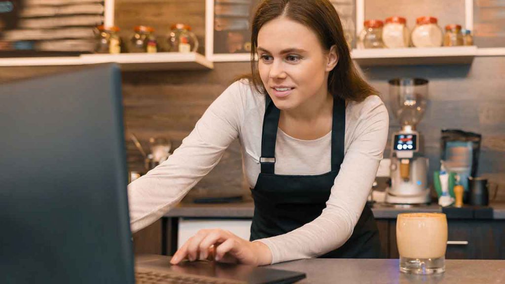 Person on laptop offering help and support, factsheets and guidance to small businesses