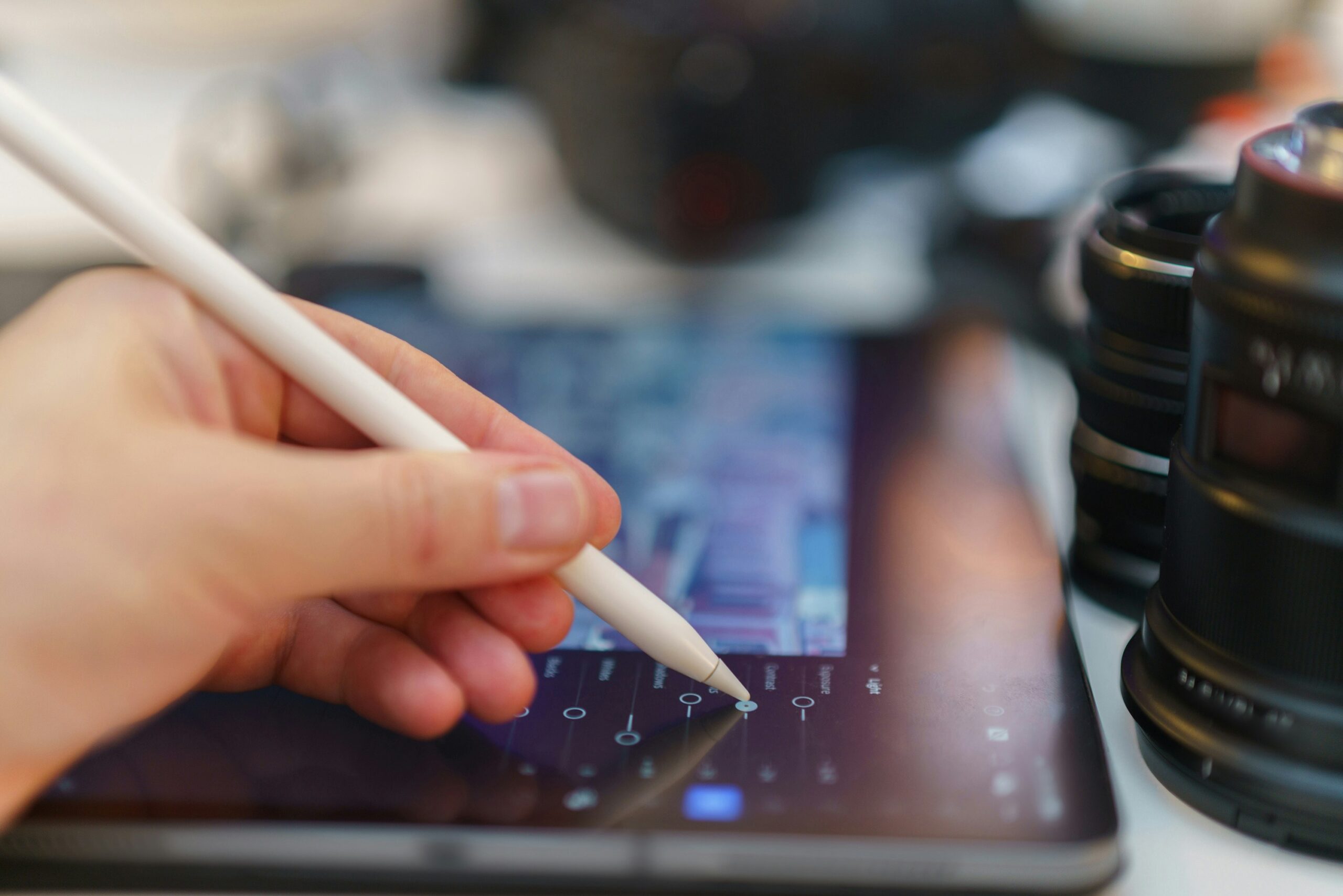 Image of person's hand writing on a tablet